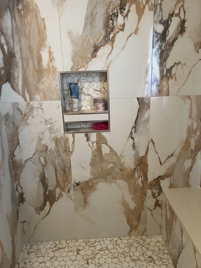 Finished tile shower with niche and bench